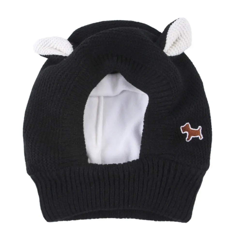 Black knitted dog hat with white ears.