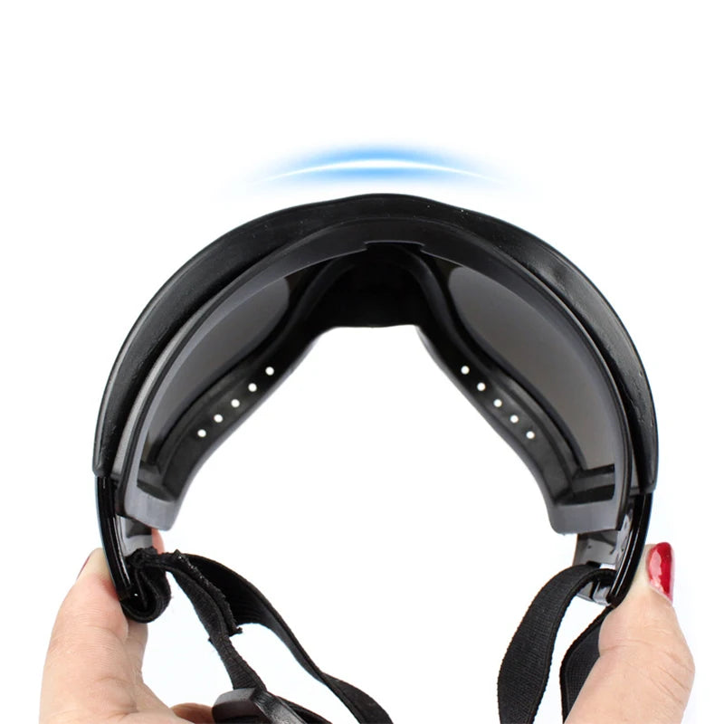 Woman's hand showing the flexible nature of UV dog goggles.