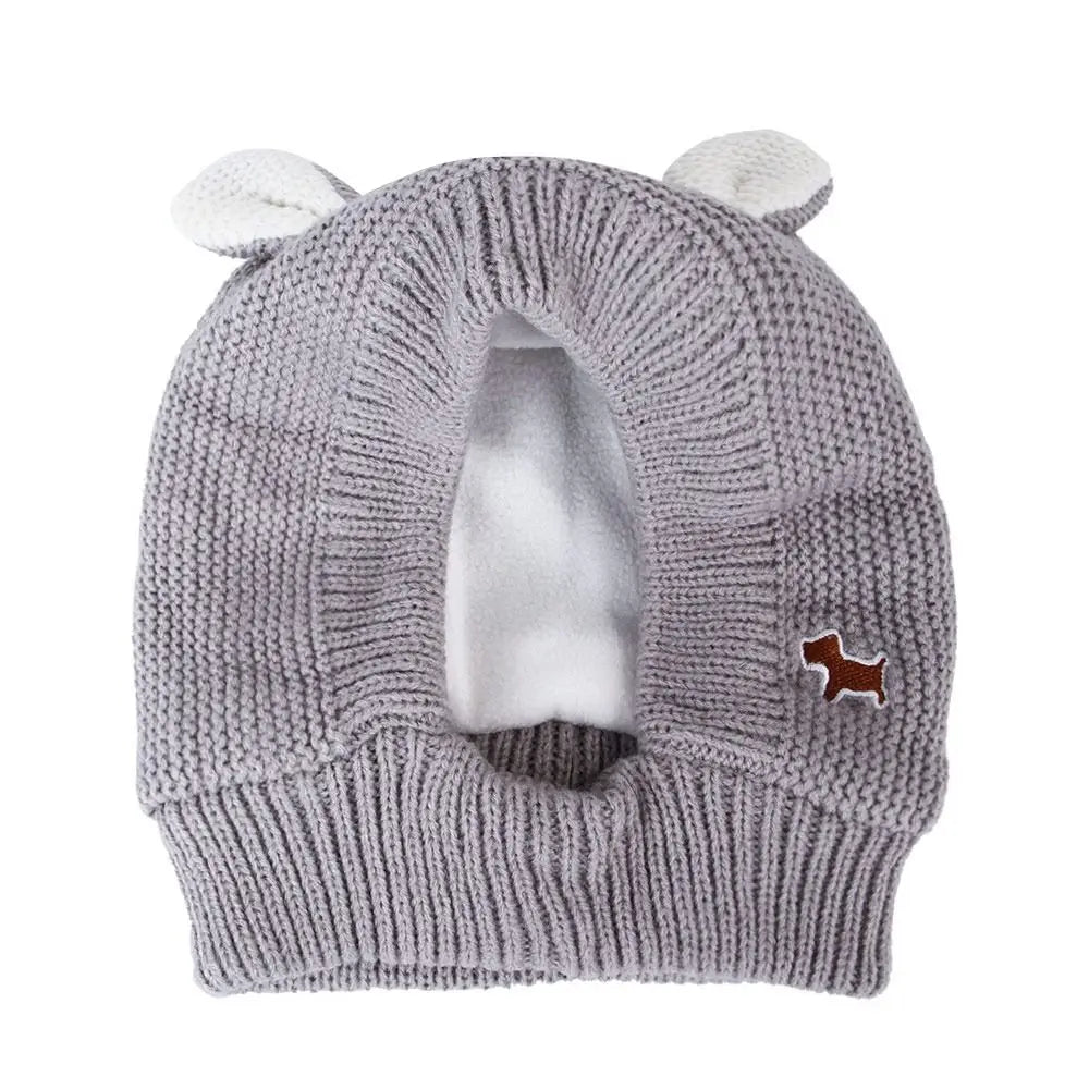 Gray knitted dog hat with white ears.