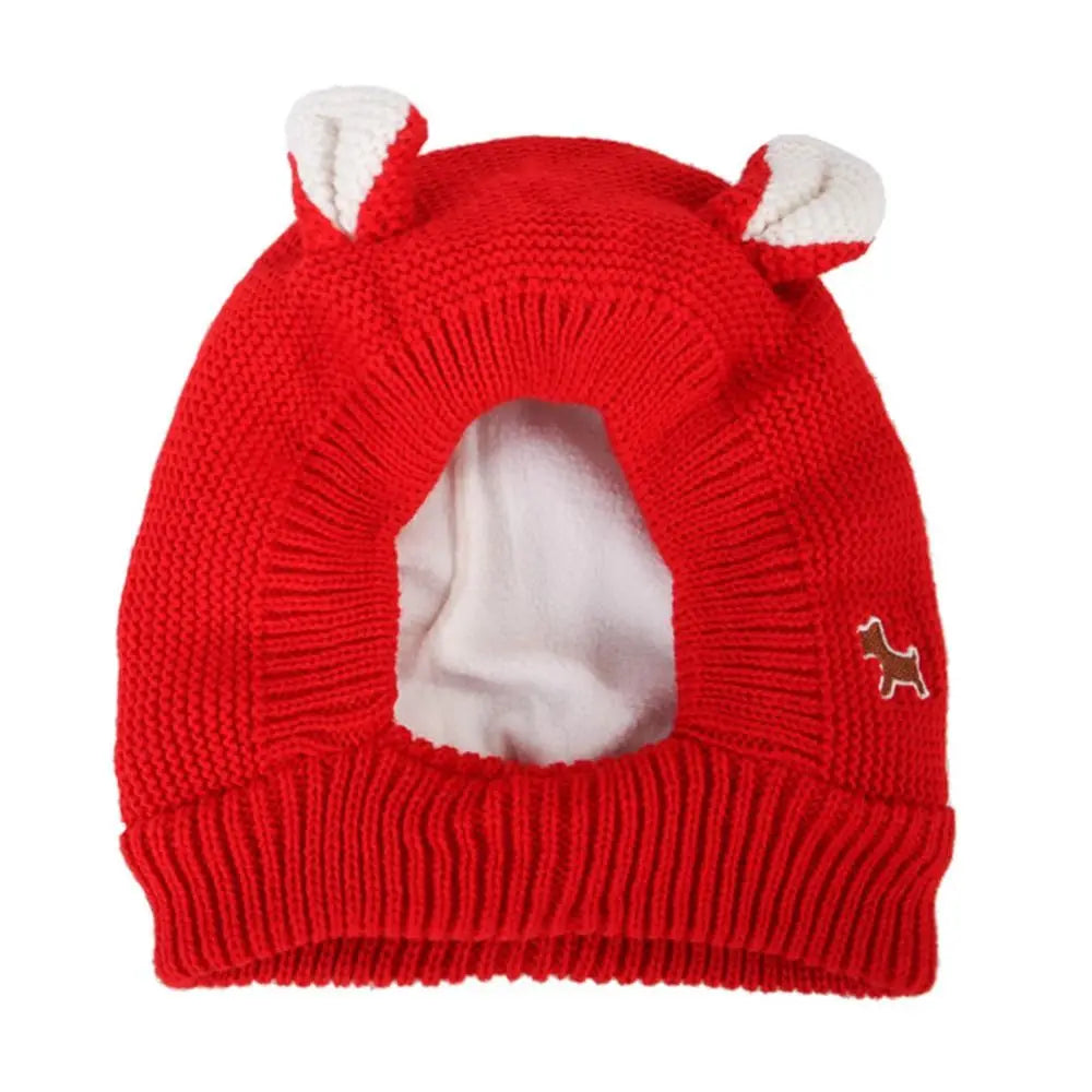 Red knitted dog hat with white ears.